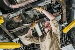 Mechanic inspecting the underside of a car for DPF cleaning in Stoke on Trent