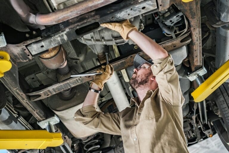 Mechanic inspecting the underside of a car for DPF cleaning in Stoke on Trent