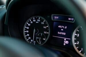 Close-up of the odometer and dashboard of a luxury car with a black interior after detailing