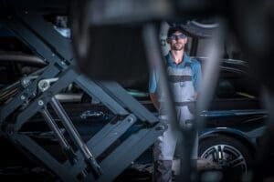 Car Mechanic Between Lifts