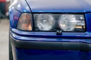 close-up At the service station part the BMW headlight deep blue washed black bumper