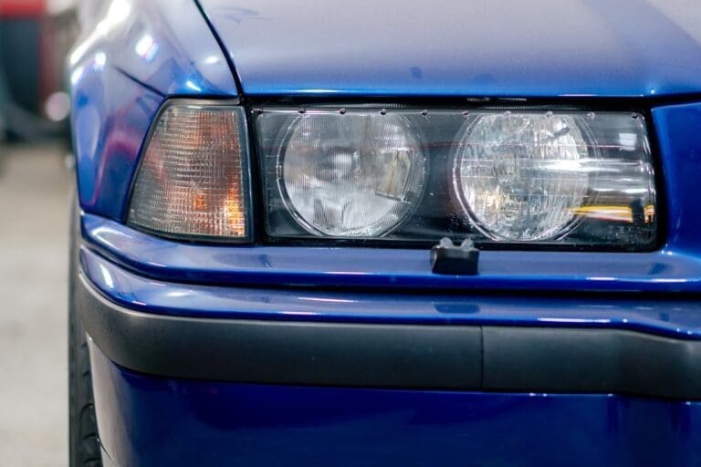 close-up At the service station part the BMW headlight deep blue washed black bumper